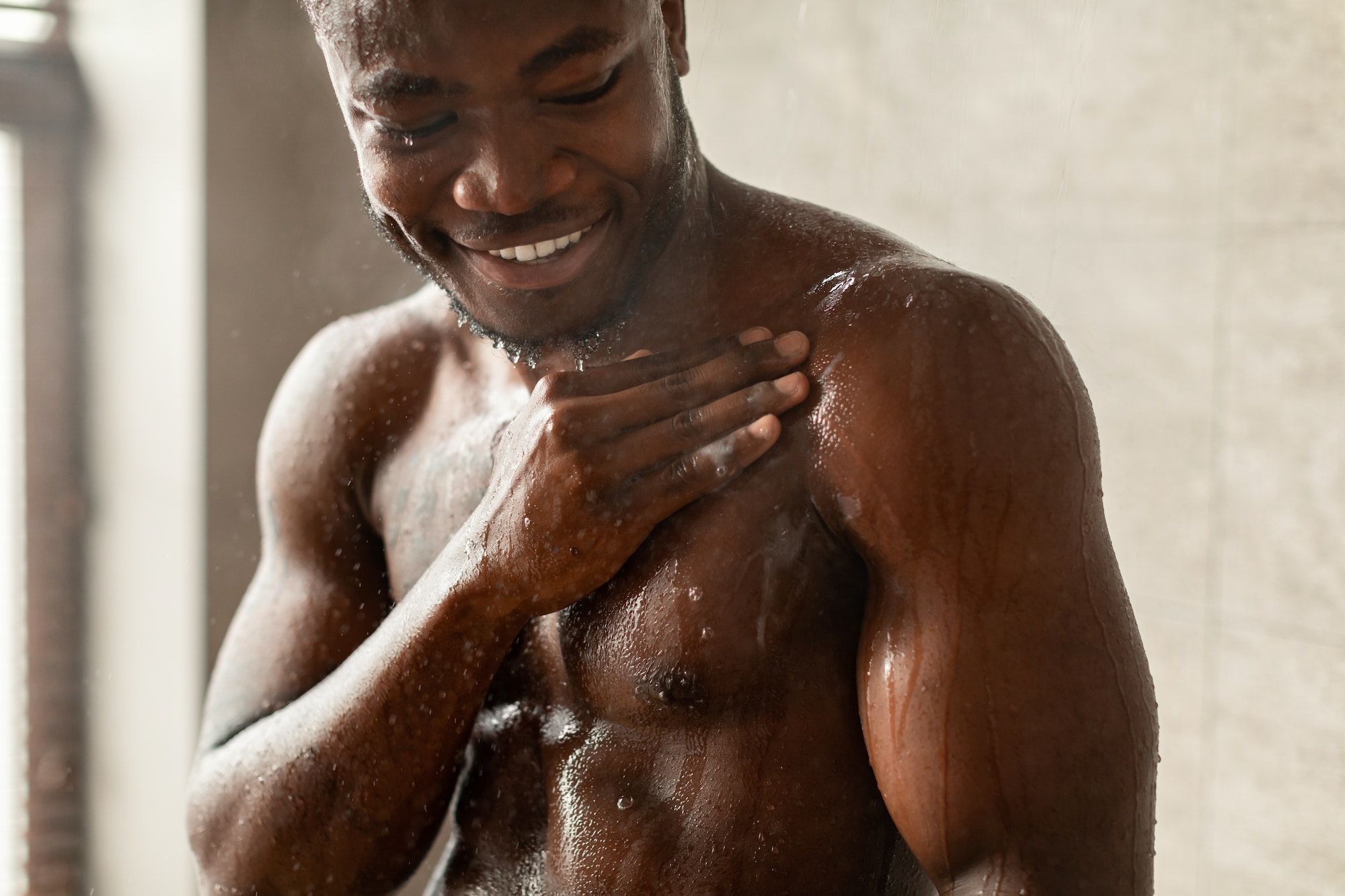 African American Guy Washing Body Taking Morning Shower Indoors
